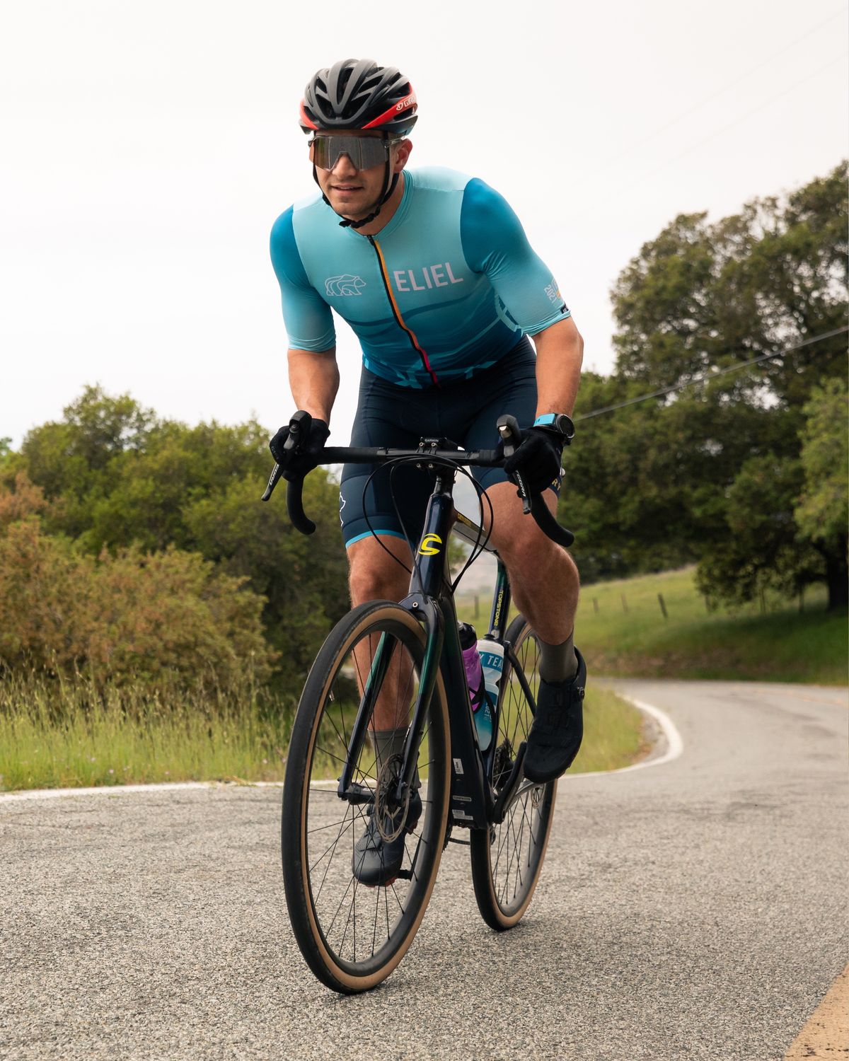 Road cyclist climbing a coastal road
