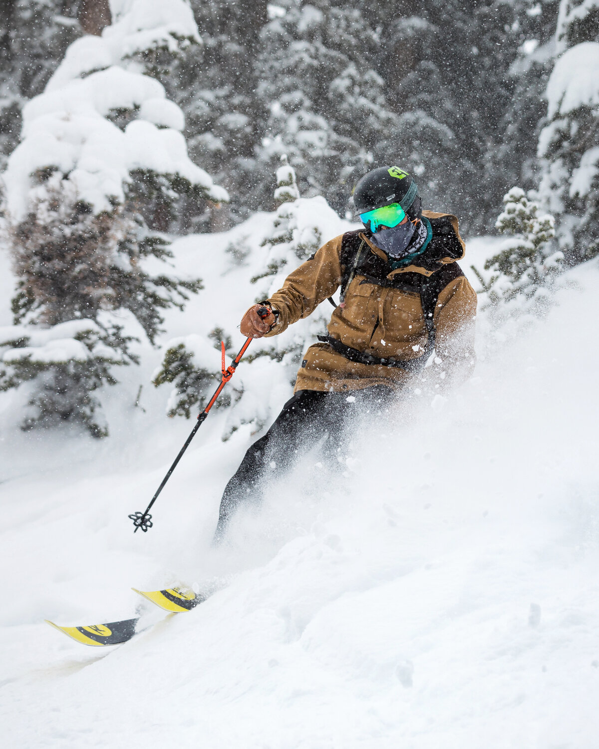 Skier carving through deep powder in the trees