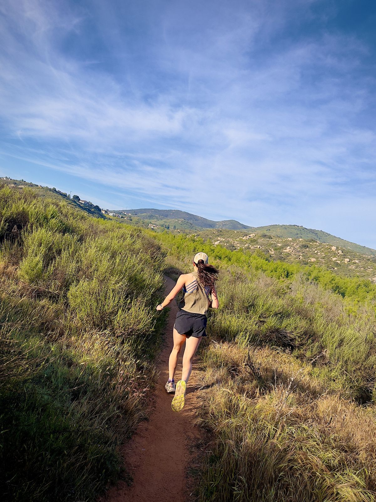 Trail runner climbing a singletrack ridge
